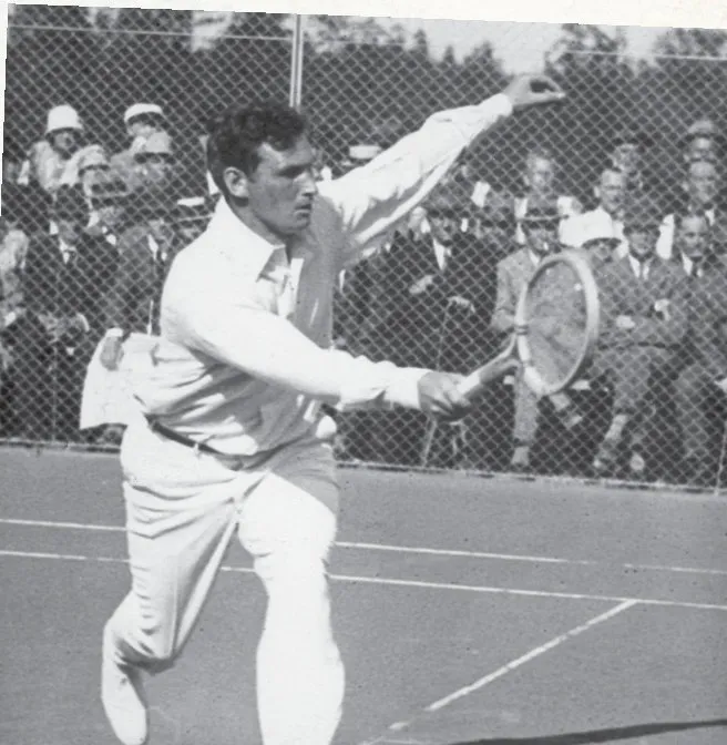 A player in white mid-stroke in front of a crowd.